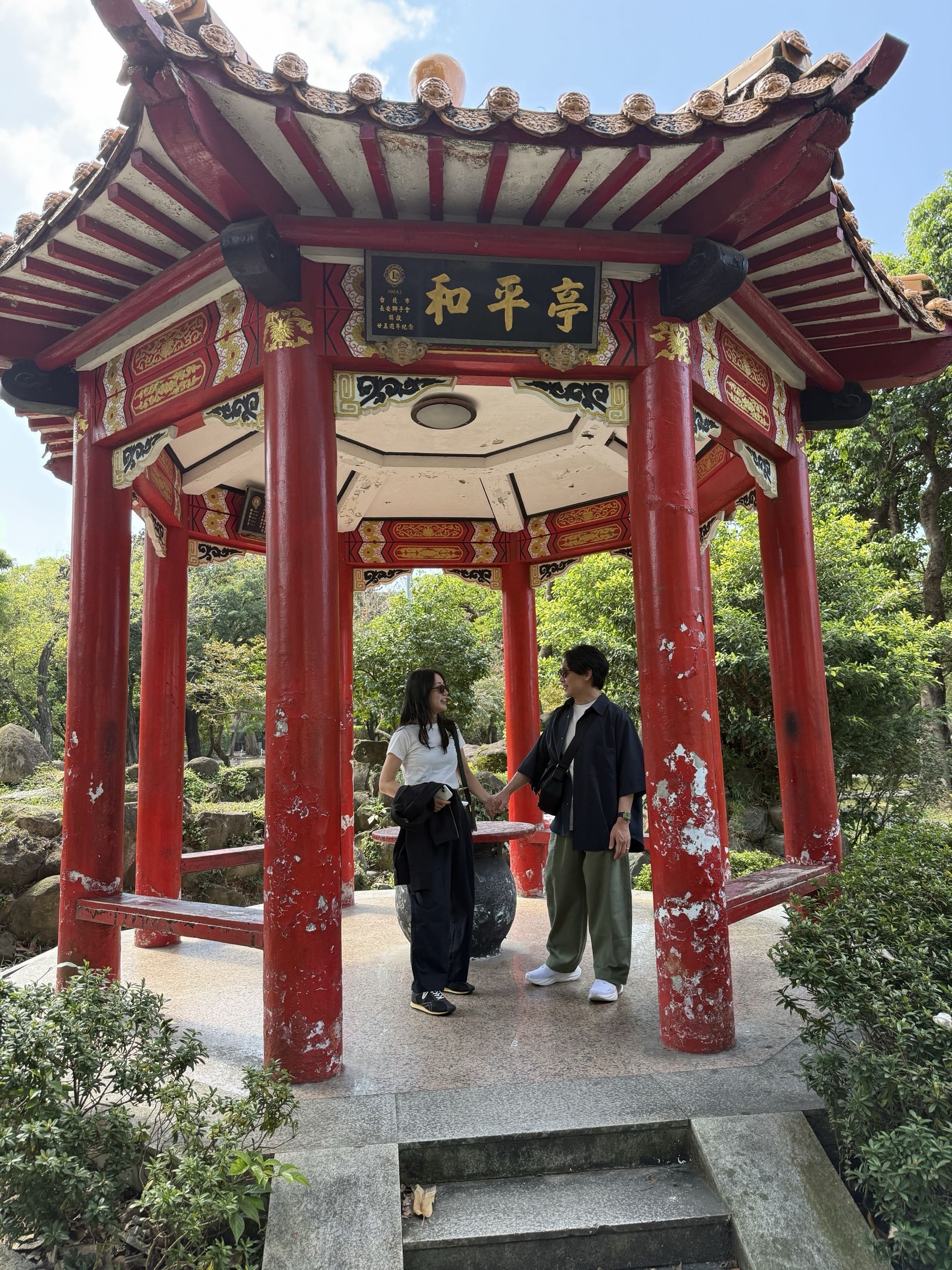 Miyuki and Peter standing in a garden pavilion